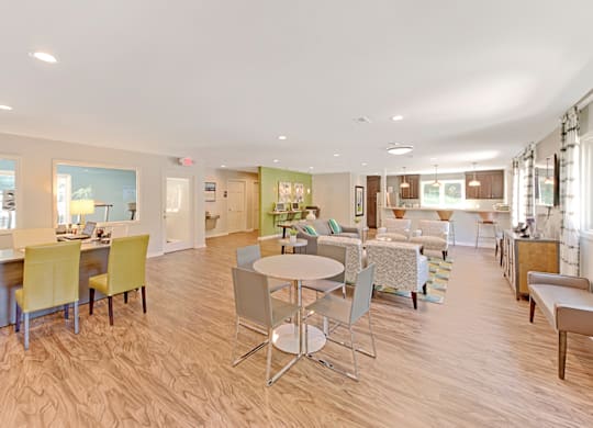 a resident clubhouse with tables and chairs and a kitchen in the background at Eastchester Ridge Apartments, High Point, 27262