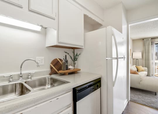 a kitchen with white cabinets and white appliances at Eastchester Ridge Apartments, High Point, NC