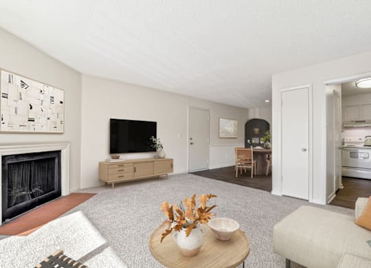 a living room with a fireplace and a dining room in the background at Eastchester Ridge Apartments, High Point, NC, 27262