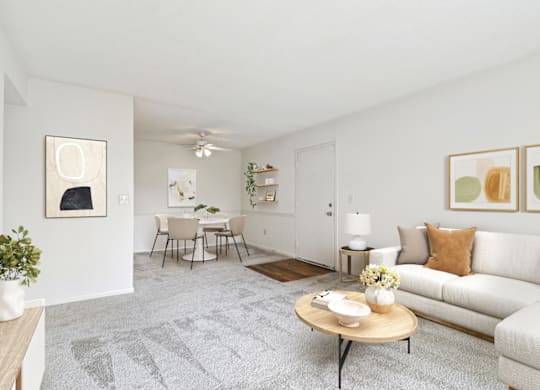 a living room with white walls and a white couch at Eastchester Ridge Apartments, High Point, NC