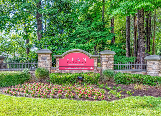 a sign that says elan at the entrance of the subdivision