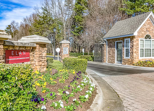 a stone building with a sign that says elan apartments