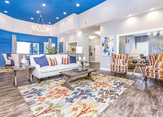a spacious living room with a blue ceiling and white walls