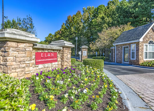 a stone building with a red sign that says elan