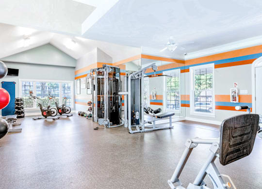 a home gym with exercise equipment and windows