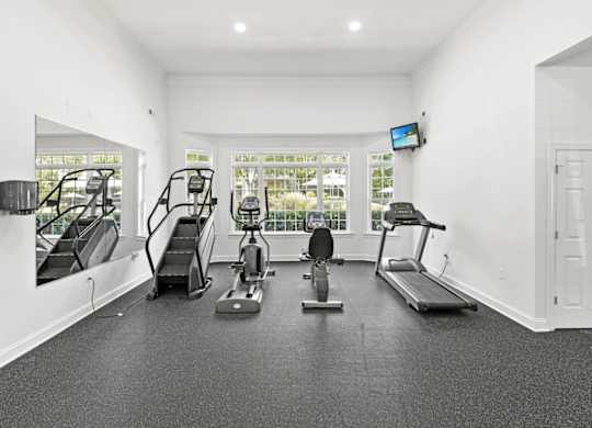 A spacious home gym with a variety of exercise equipment.