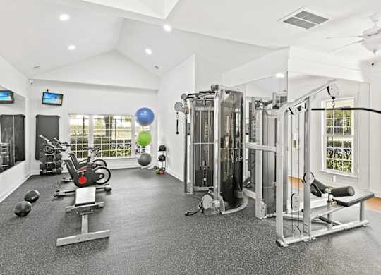 A spacious home gym with a variety of exercise equipment.