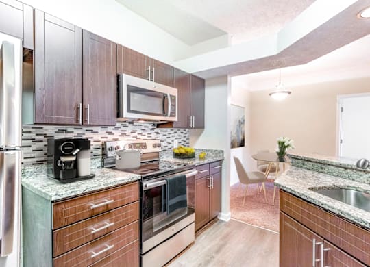 a kitchen with wooden cabinets and stainless steel appliances