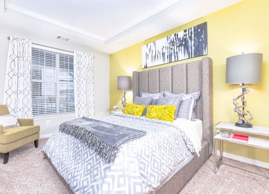 a bedroom with yellow walls and a large bed