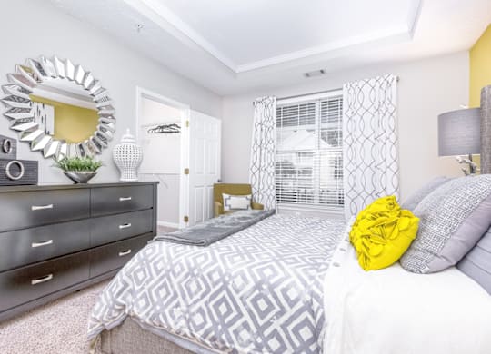 a bedroom with a bed and dresser