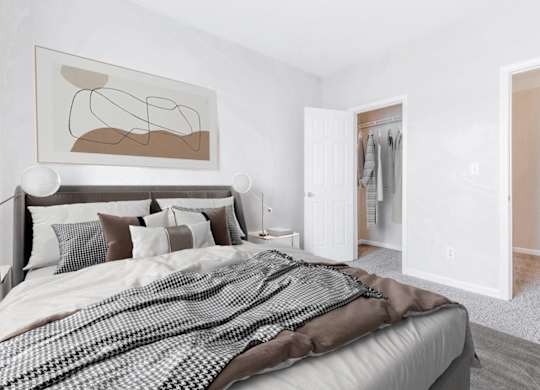 A bedroom with a large bed and a painting on the wall.