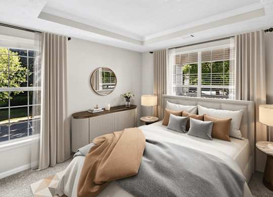 A bedroom with a large bed, a round mirror, and a window with blinds.