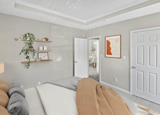 A living room with a grey couch and a white door.
