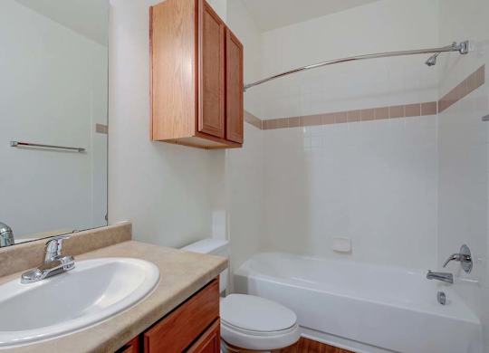 A white sink is on a beige countertop in a bathroom at Ethan Pointe Apartments, Greensboro, NC, 27215