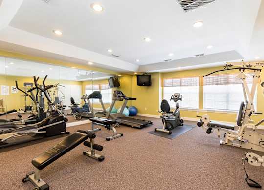 A well-equipped gym with various exercise machines and equipment.