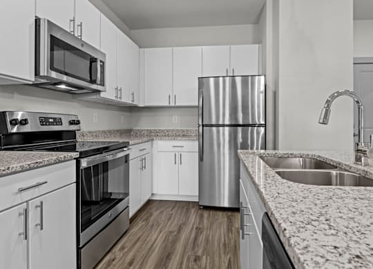A modern kitchen with white cabinets and stainless steel appliances at Litchford 315 Apartments, Raleigh