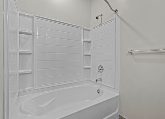 A white bathroom with a bathtub and a shower at Litchford 315 Apartments, North Carolina