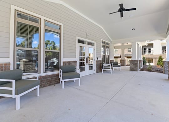 A patio with a ceiling fan and chairs at Litchford 315 Apartments, North Carolina