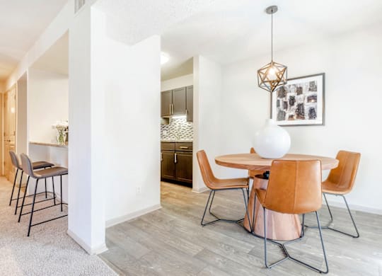 A dining room with a white table and chairs at Madison Southpark Apartment Homes, Charlotte, NC, 28226
