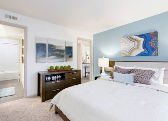 A bedroom with a large bed and a painting on the wall at Madison Southpark Apartment Homes, Charlotte, North Carolina
