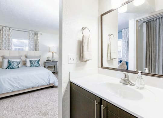 A white bathroom with a bed and a mirror at Madison Southpark Apartment Homes, North Carolina