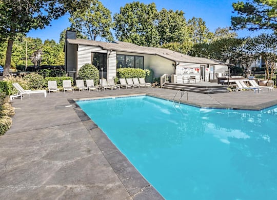 A swimming pool in front of a house at Madison Southpark Apartment Homes, Charlotte, 28226