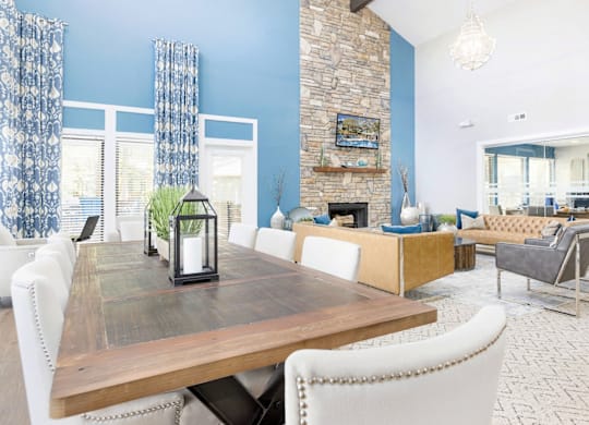 A dining room with a wooden table and white chairs at Madison Southpark Apartment Homes, Charlotte, NC, 28226