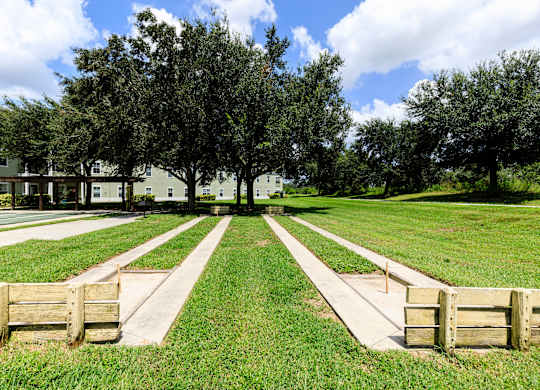 A park with a pathway and benches.