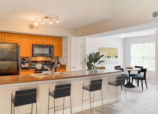 kitchen bar with barstools at Central on the Green Apartment Homes, North Carolina, 27604