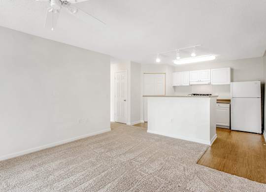 A white kitchen with a refrigerator, stove, and cabinets. at The Grayson Apartment Homes, Charlotte, North Carolina