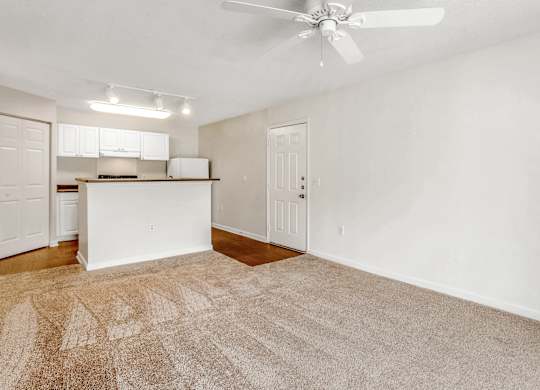 A room with a ceiling fan and carpeted floor. at The Grayson Apartment Homes, Charlotte, 28262