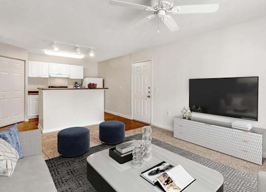 A living room with a white ceiling fan and a flat screen TV. at The Grayson Apartment Homes, North Carolina, 28262