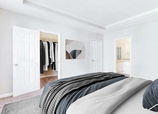 A bedroom with a bed, a wardrobe, and a mirror.