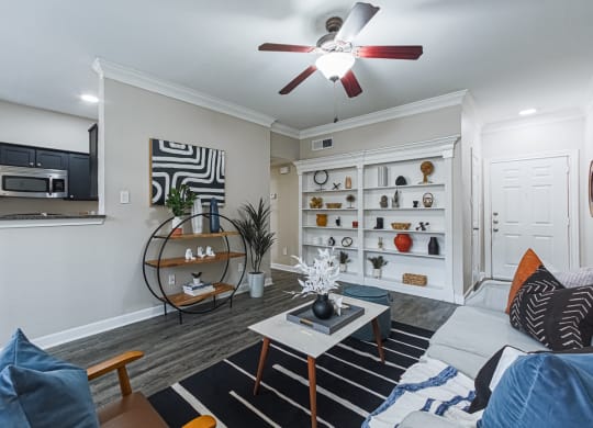 a living room with hardwood-style flooring and a ceiling fan
