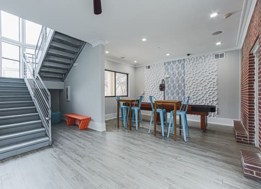 clubhouse lounge with a table and a staircase
