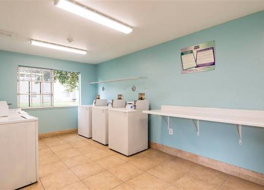 A laundry room with washer and dryer machines.
