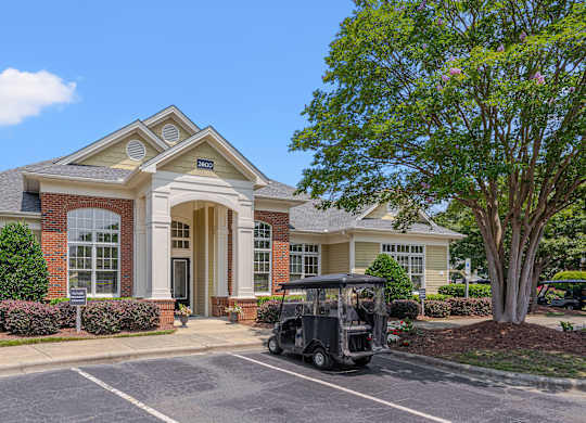 A house with a golf cart parked in front.