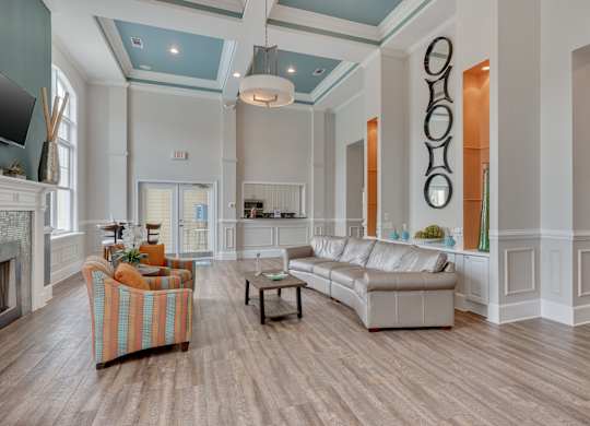 Clubhouse living room with a fireplace and a striped chair.