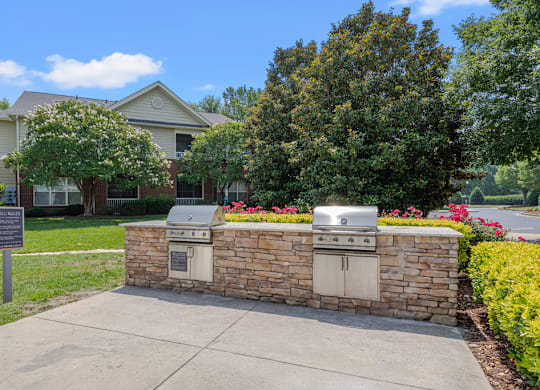 A brick wall with a grill on top of it.