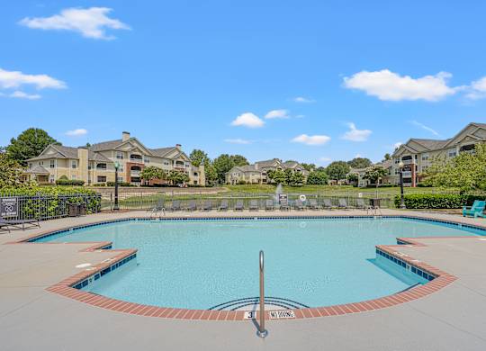 A swimming pool surrounded by apartment buildings