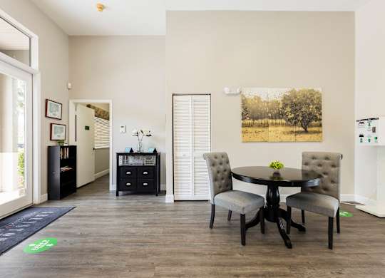 A dining room with a table and chairs.