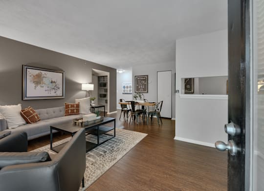 A living room with a grey couch and a coffee table.