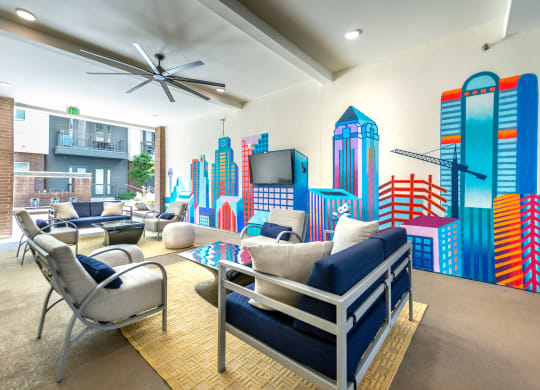 Outdoor covered patio with vibrant Dallas skyline painting and seating