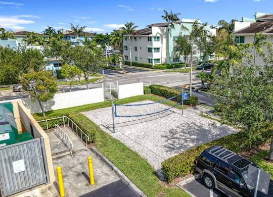 A parking lot with cars and a building in the background.
