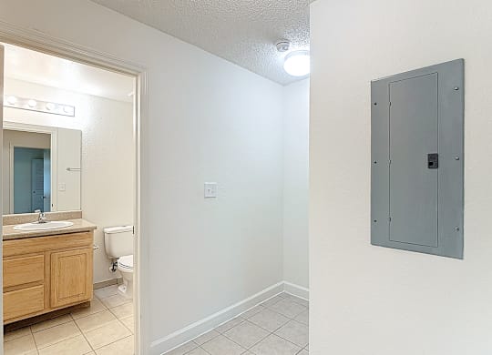 A bathroom with a toilet, sink, and medicine cabinet.