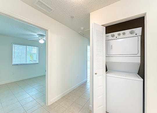 A white oven is built into a wall in a kitchen.