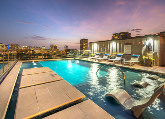 Rooftop pool facing downtown Dallas at night