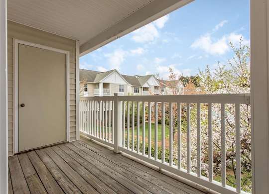 Private Balcony with Wood Flooring and White Railing