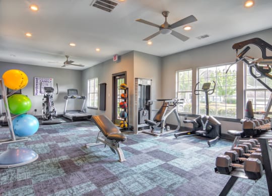 Fitness room with workout equipment in front of exterior window