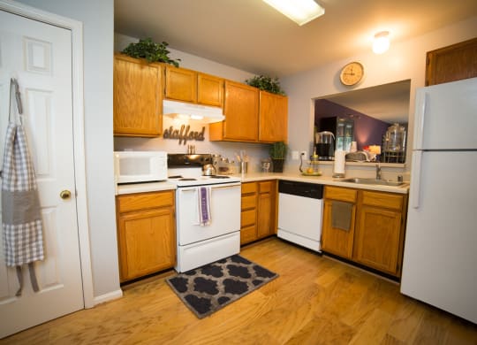 Kitchen with white appliances and wood cabinets